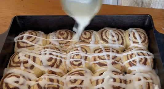 Hands rolling out dough with rolling pin